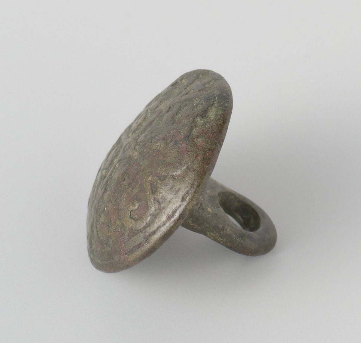 Brass button with four fleurs-de-lis