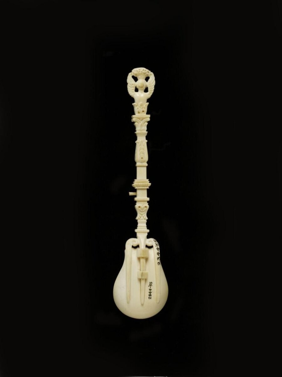 Spoon, ivory, handle carved in sphinx-like female head