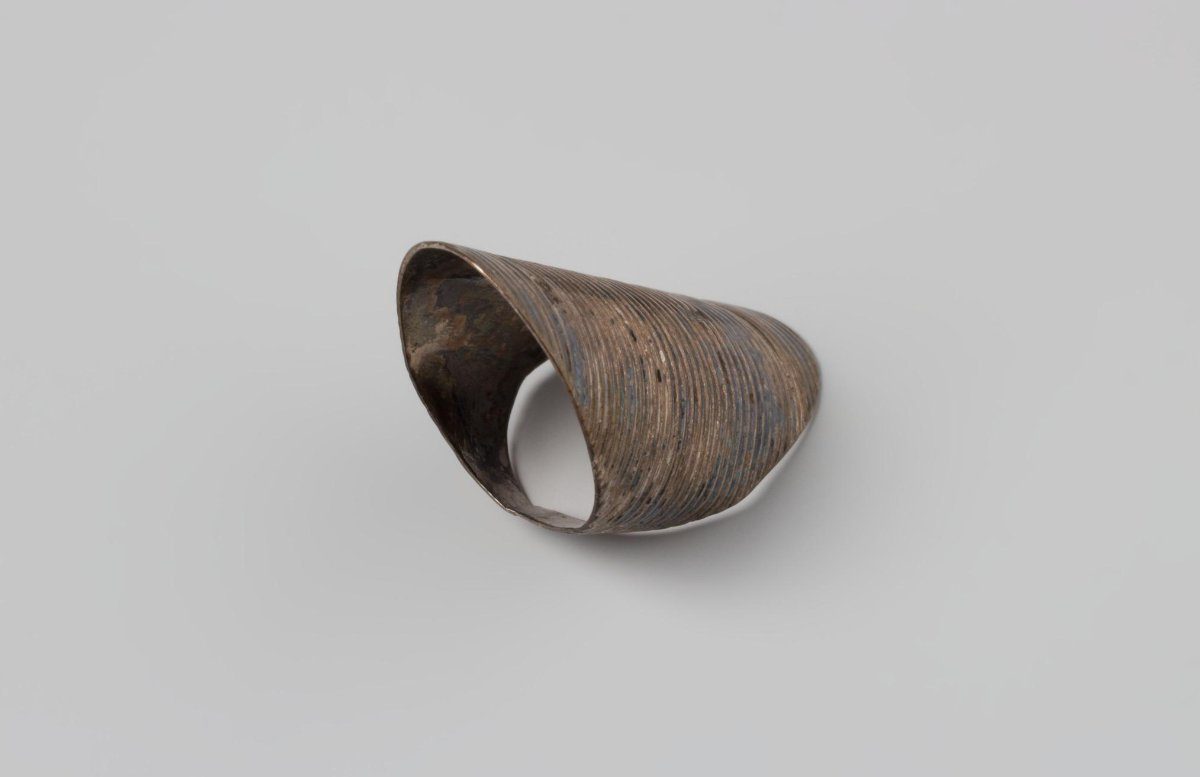 Silver thimble, as a flat ring with a wide nail-protecting upper section