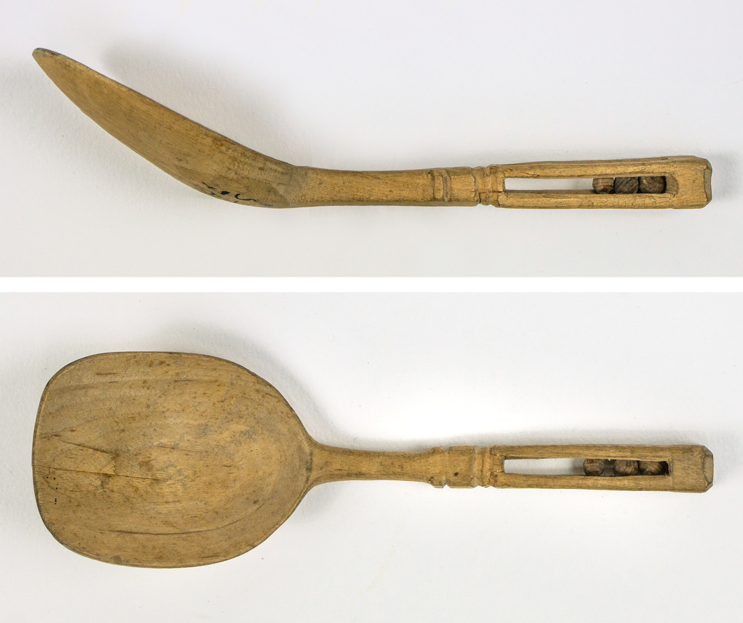 Carved wooden spoon containing a cavity with three balls, a courtship gift, known as a "känning"