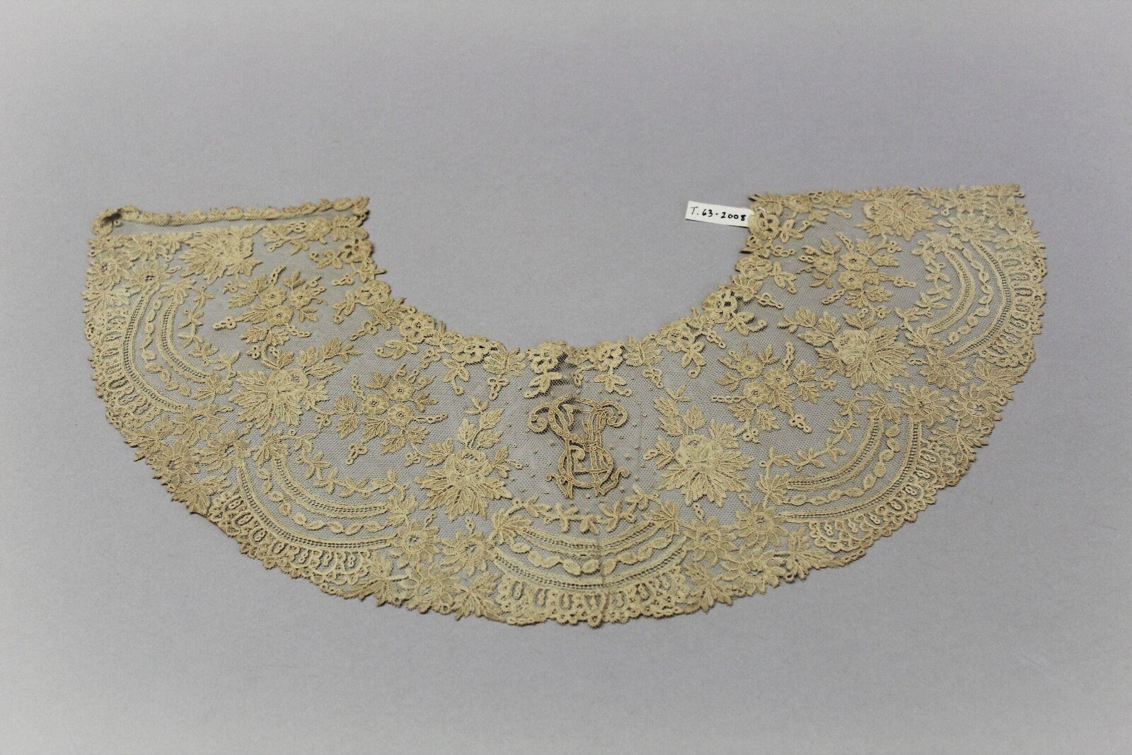 Fan leaf, bobbin and needle lace with monogram HSE, Brussels, 1860s — museum object T.63-2008