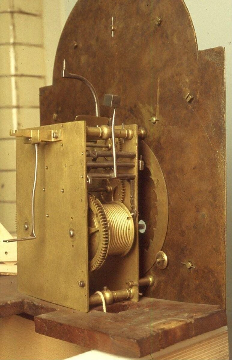 A long-case clock with green and gold japanned case