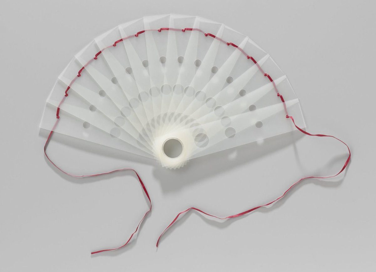 Brisé fan made of polypropylene with pierced circles, with red satin ribbon