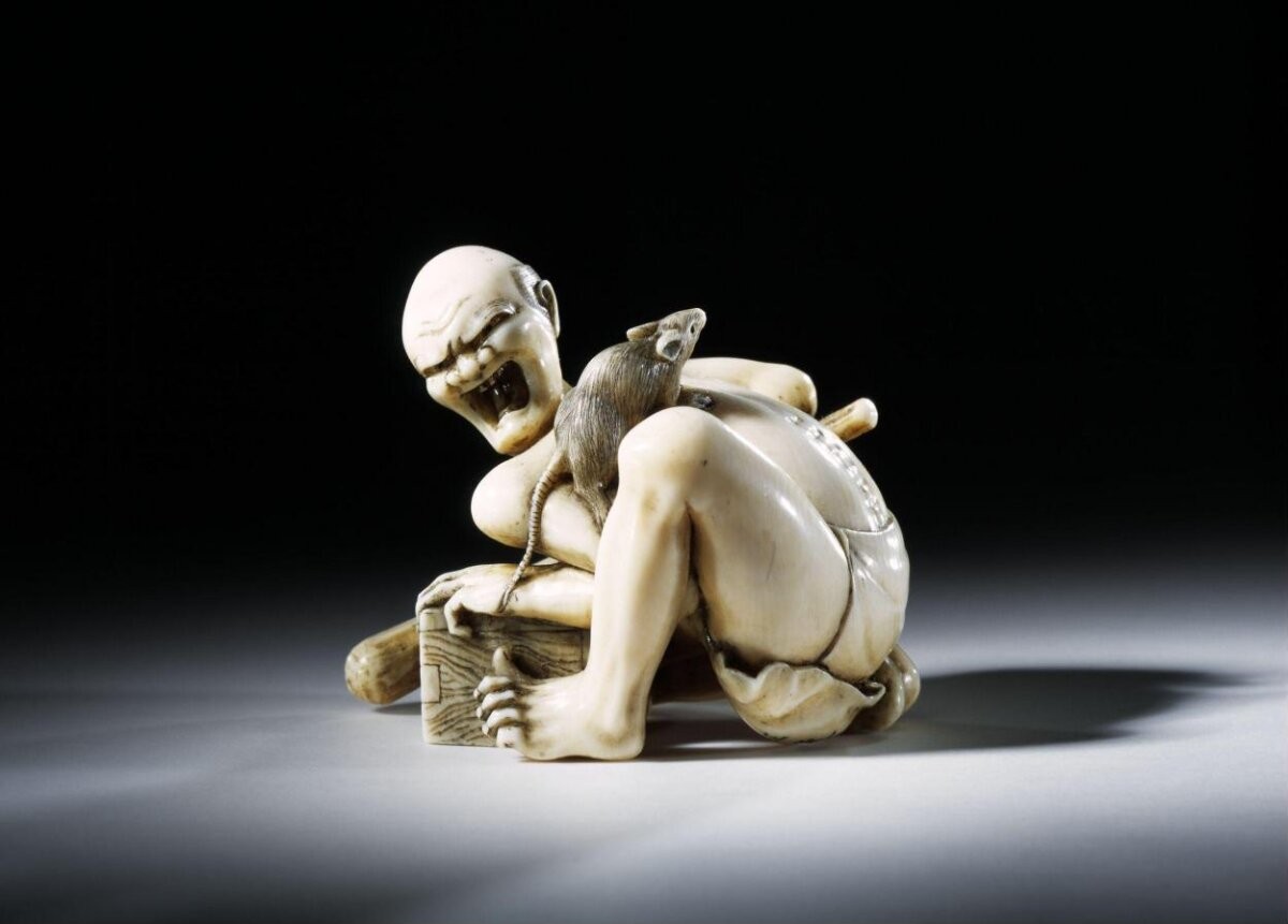 Netsuke in the form of a thwarted rat catcher, carved ivory, signed Masanari(?) or Seikei(?), Japanese, 19th century.