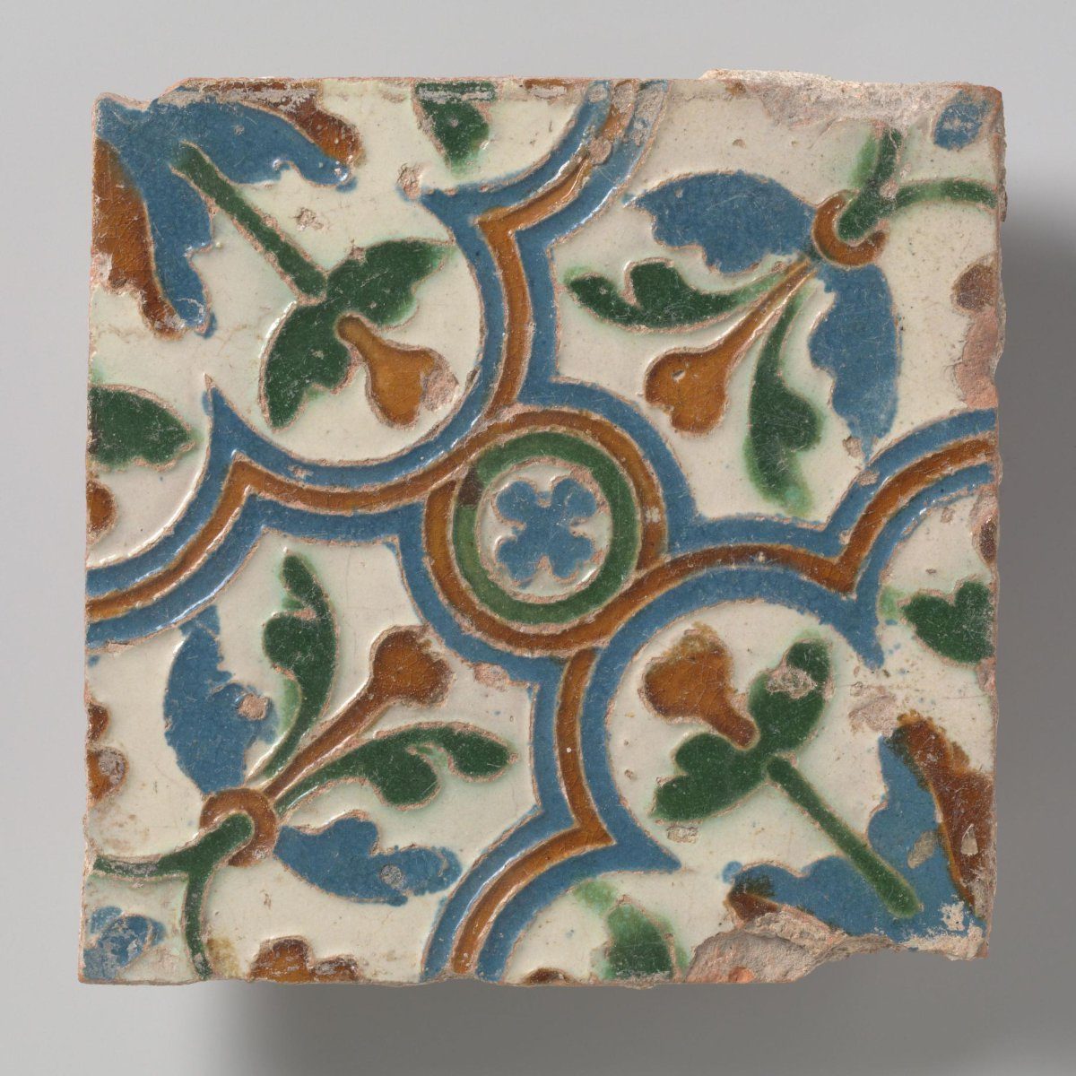 Cuenca tile with medallion containing rosette; four adjoining corner compartments.