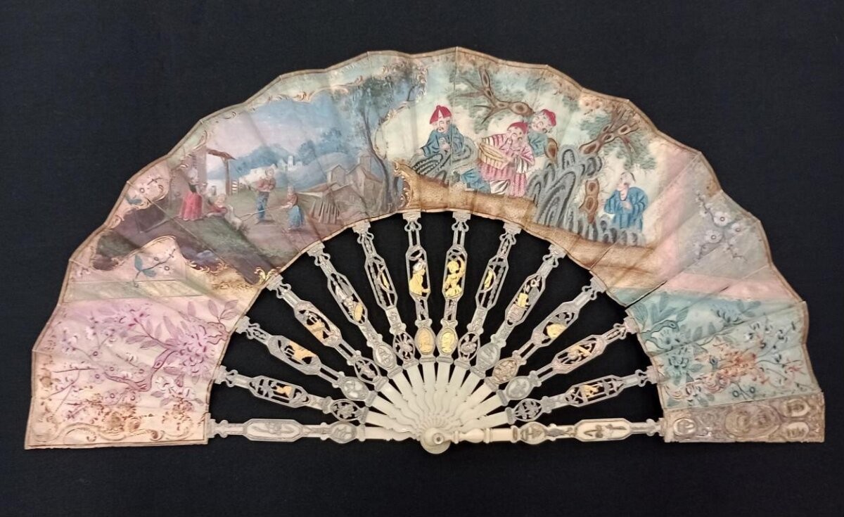 Fan of water colour on vellum with mother-of-pearl sticks, ivory guards, 1770-1790, probably French; chinoiserie and rustic European scenes