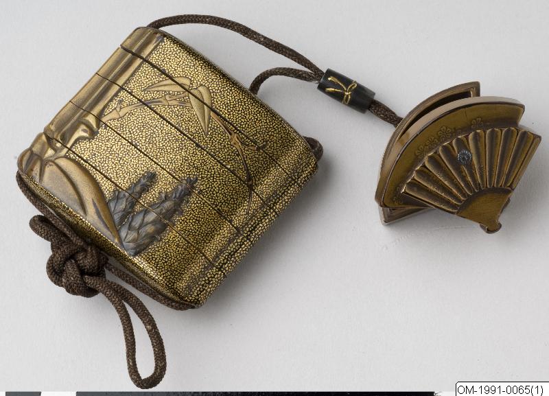 Inro in four compartments and lid. Decoration with bamboo executed in gold lacquer. 
H: 6.7 cm
W: 7.2 cm
Belongs together with 0065b (ojime) and 0066 (netsuke)
Object marked A.
(Edited when A-B markin