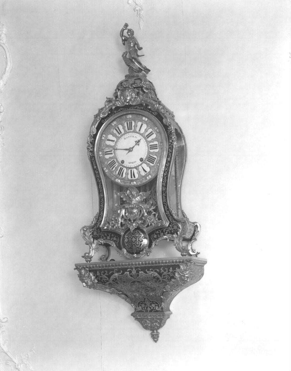 Carcase probably of oak, the bracket of pine, both veneered in boulle marquetry of turtleshell and brass, with gilt-brass mounts; the dial plate enamelled in white, blue and black