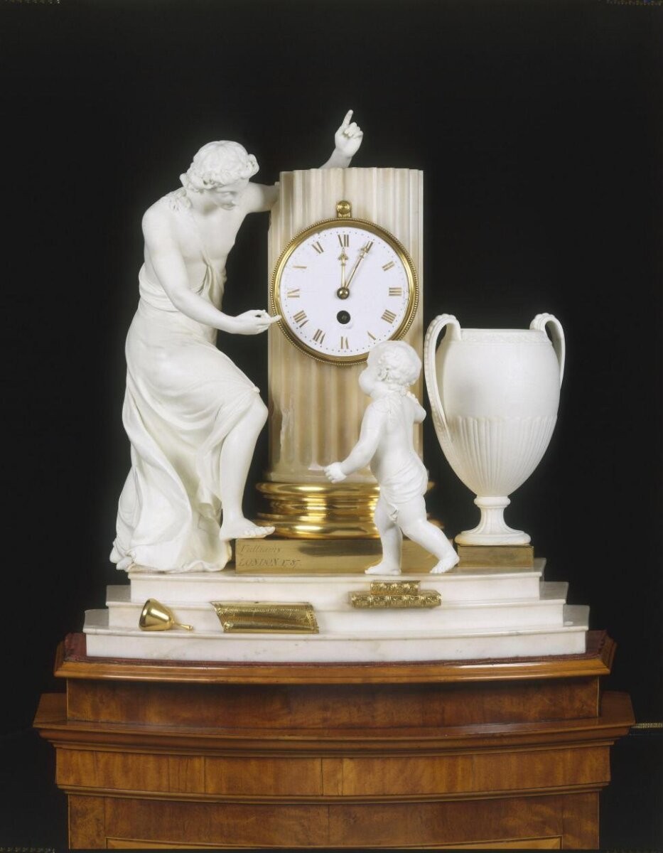A clock in a case of marble and Derby porcelain, mounted on a tall plinth