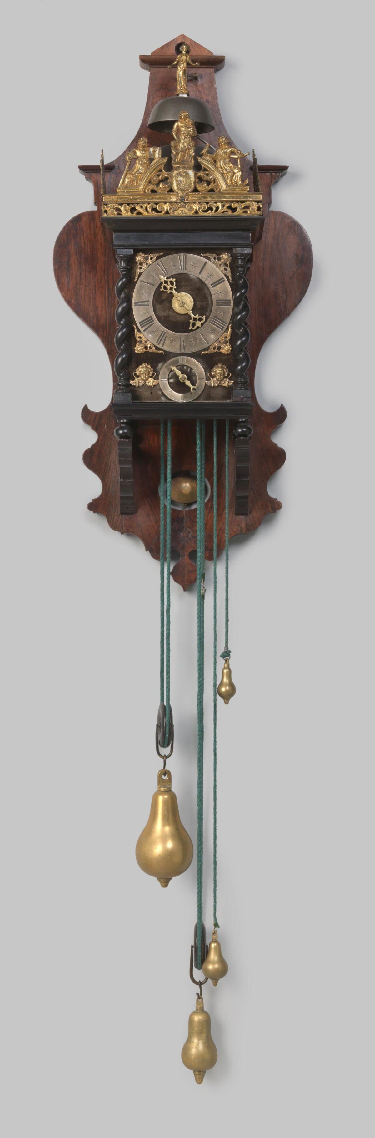 Wall clock with molded base and cornice and twisted corner columns, on a vase-shaped backboard
