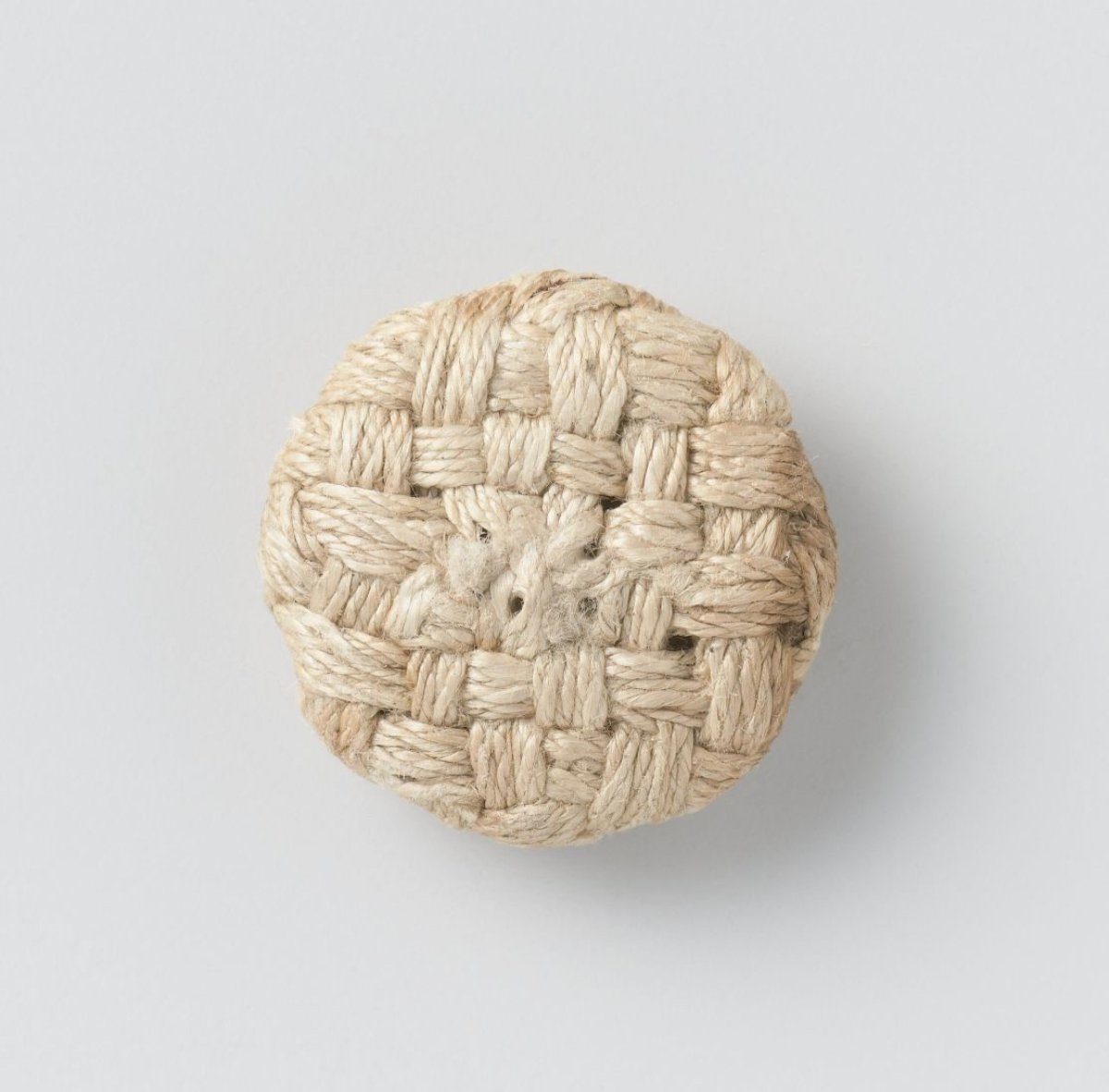 Button of braided fabric
