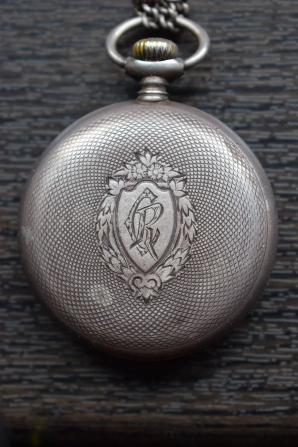 The silver-made Omega pocket watch presented by General Henri Berthelot to Father Constantin I. Roșescu, a Romanian Orthodox priest and teacher from Iași, that became his friend during the WWI French campaign in Romania. The backplate is engraved with "CR", Roșescu's initials. Fa