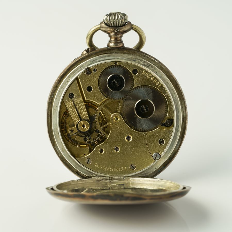Longines manual winding pocket watch , model 4 Grand Prix, silver casing, manufactured approx. 1900. Rear view, wear marks, clockwork visible. Enhanced resolution.